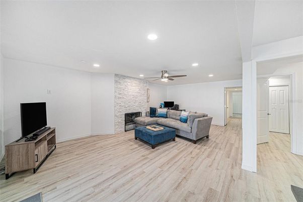 Fireplace, Interior, Living room, Recessed Lighting, Stone Walls, Wood Texture Flooring