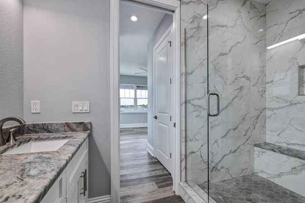Bathroom, Dual Sink Vanities, Glass Shower, Interior, Marble Walls, Recessed Lighting, Wood Texture Flooring