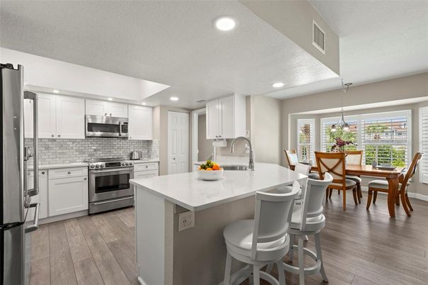 Dining room, Interior, Kitchen, Pendant Lights, Recessed Lighting, Stainless Steel Appliances, Wood Texture Flooring
