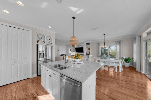 Chandelier, Dining room, Interior, Kitchen, Pendant Lights, Recessed Lighting, Stainless Steel Appliances, Wood Texture Flooring