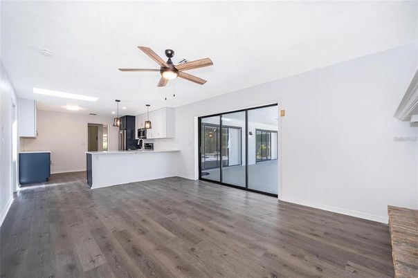 Empty room, Interior, Kitchen, Pendant Lights, Recessed Lighting, Stainless Steel Appliances, Wood Texture Flooring