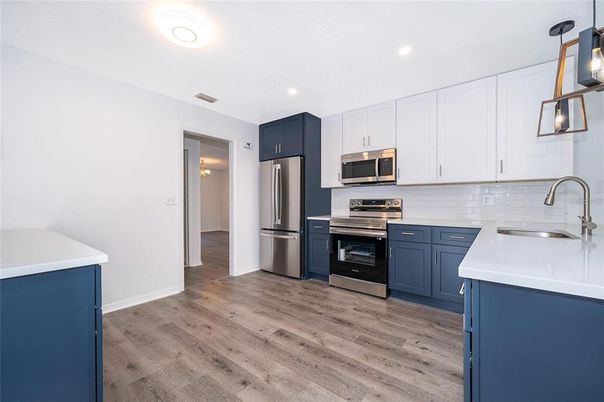 Interior, Kitchen, Recessed Lighting, Stainless Steel Appliances, Wood Texture Flooring