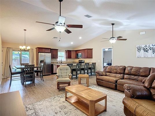 Chandelier, Dining room, Interior, Kitchen, Living room, Pendant Lights, Recessed Lighting, Stainless Steel Appliances, Wood Texture Flooring