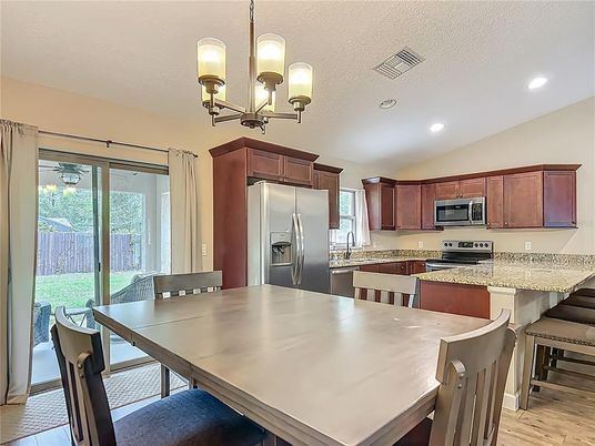 Chandelier, Dining room, Interior, Kitchen, Recessed Lighting, Stainless Steel Appliances, Wood Texture Flooring