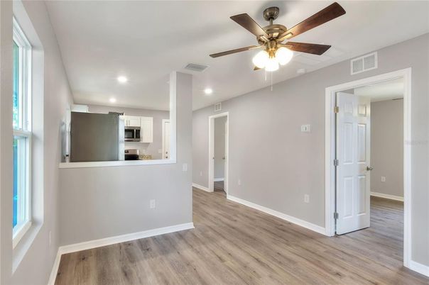 Empty room, Interior, Kitchen, Recessed Lighting, Stainless Steel Appliances, Wood Texture Flooring