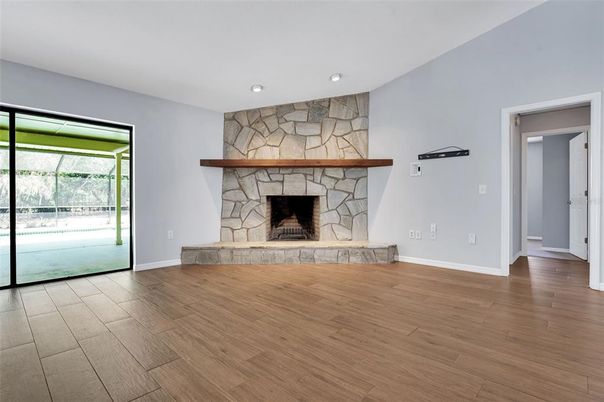 Empty room, Fireplace, Interior, Recessed Lighting, Stone Walls, Wood Texture Flooring