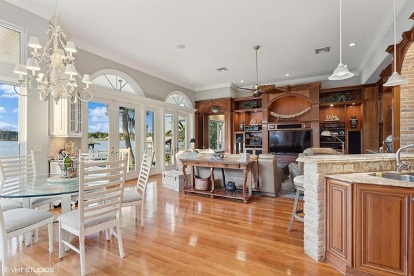 Chandelier, Dining room, Interior, Living room, Pendant Lights, Recessed Lighting, Stone Walls, Water, Wood Texture Flooring