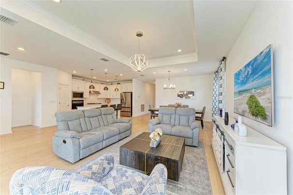 Chandelier, Dining room, Interior, Kitchen, Living room, Pendant Lights, Recessed Lighting, Stainless Steel Appliances, Wood Texture Flooring