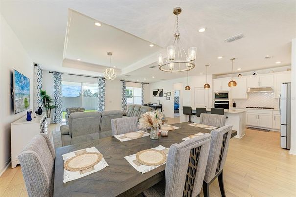 Chandelier, Dining room, Interior, Kitchen, Living room, Pendant Lights, Recessed Lighting, Stainless Steel Appliances, Wood Texture Flooring