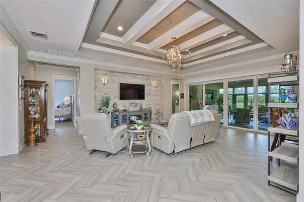 Chandelier, Fireplace, Interior, Living room, Recessed Lighting, Stone Walls, Wood Texture Flooring