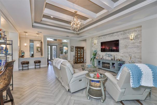 Chandelier, Fireplace, Interior, Living room, Pendant Lights, Recessed Lighting, Stone Walls, Wood Texture Flooring