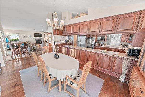 Chandelier, Dining room, Interior, Kitchen, Pendant Lights, Recessed Lighting, Stainless Steel Appliances, Wood Texture Flooring
