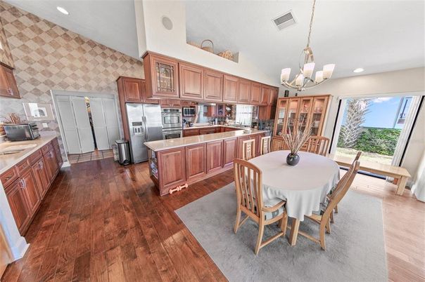 Chandelier, Dining room, Interior, Kitchen, Recessed Lighting, Stainless Steel Appliances, Wood Texture Flooring