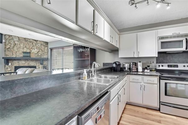 Fireplace, Interior, Kitchen, Stainless Steel Appliances, Stone Walls, Wood Texture Flooring