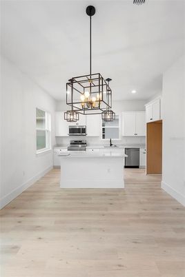 Chandelier, Interior, Kitchen, Pendant Lights, Recessed Lighting, Stainless Steel Appliances, Wood Texture Flooring