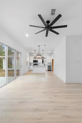 Empty room, Interior, Kitchen, Pendant Lights, Recessed Lighting, Stainless Steel Appliances, Wood Texture Flooring