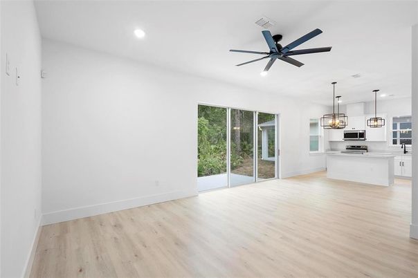Empty room, Interior, Kitchen, Pendant Lights, Recessed Lighting, Stainless Steel Appliances, Wood Texture Flooring