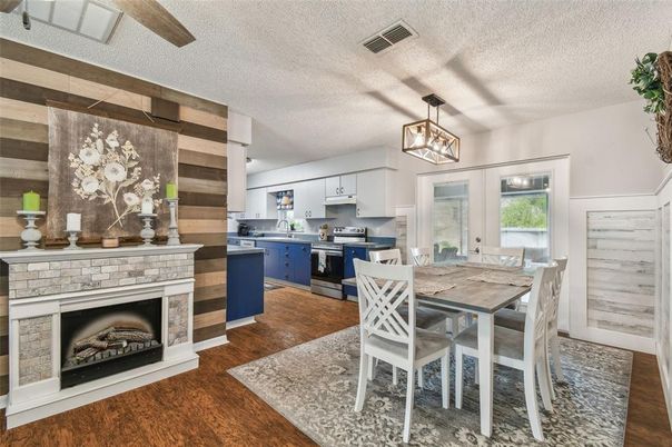 Dining room, Fireplace, Interior, Kitchen, Pendant Lights, Stainless Steel Appliances, Wood Texture Flooring