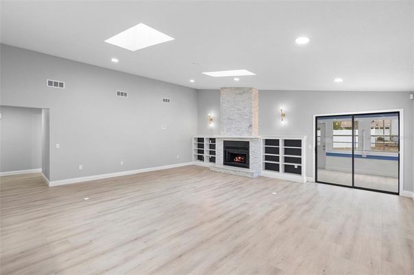 Empty room, Fireplace, Interior, Recessed Lighting, Stone Walls, Wood Texture Flooring
