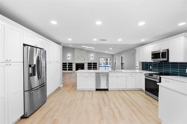 Fireplace, Interior, Kitchen, Recessed Lighting, Stainless Steel Appliances, Stone Walls, Wood Texture Flooring