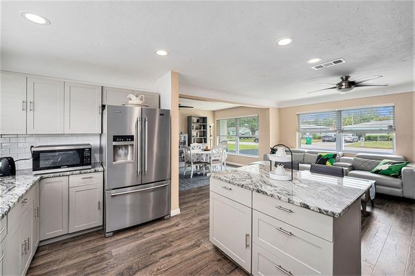 Dining room, Interior, Kitchen, Living room, Recessed Lighting, Stainless Steel Appliances, Wood Texture Flooring