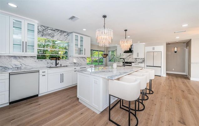 Chandelier, Interior, Kitchen, Marble Walls, Recessed Lighting, Stainless Steel Appliances, Wood Texture Flooring