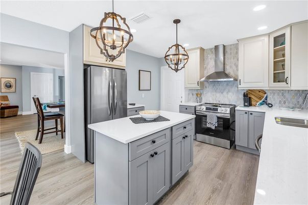Chandelier, Dining room, Interior, Kitchen, Pendant Lights, Recessed Lighting, Stainless Steel Appliances, Wood Texture Flooring