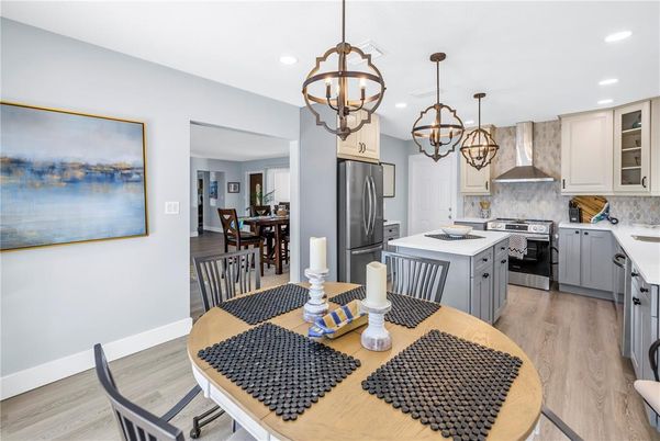 Chandelier, Dining room, Interior, Kitchen, Pendant Lights, Recessed Lighting, Stainless Steel Appliances, Wood Texture Flooring