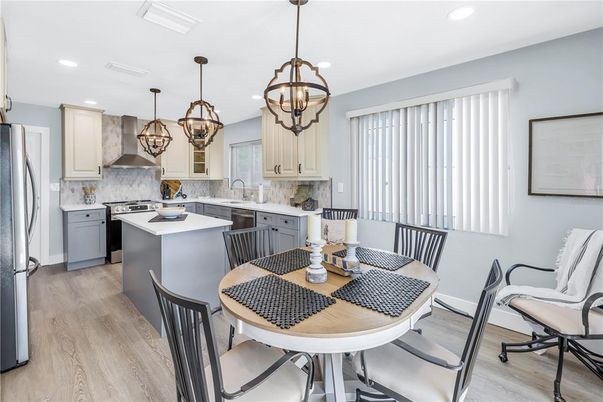 Chandelier, Dining room, Interior, Kitchen, Pendant Lights, Recessed Lighting, Stainless Steel Appliances, Wood Texture Flooring