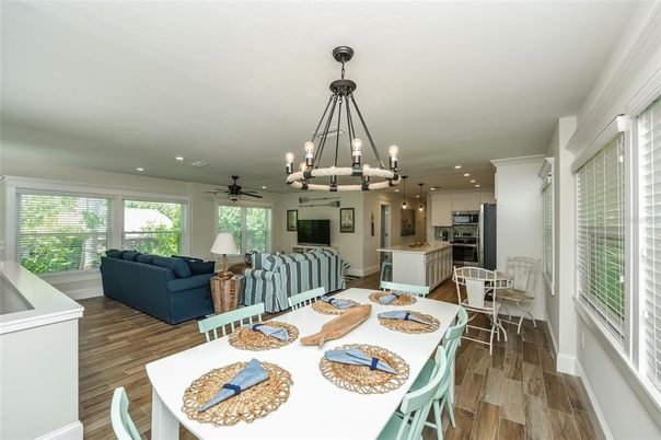Chandelier, Dining room, Interior, Kitchen, Living room, Pendant Lights, Recessed Lighting, Stainless Steel Appliances, Wood Texture Flooring