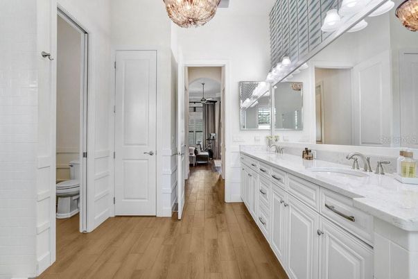 Bathroom, Chandelier, Dual Sink Vanities, Interior, Wood Texture Flooring