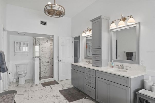 Bathroom, Dual Sink Vanities, Glass Shower, Interior, Marble, Marble Walls, Pendant Lights