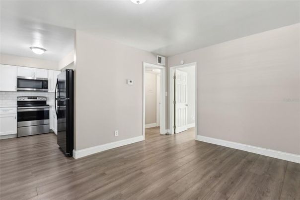 Empty room, Interior, Kitchen, Stainless Steel Appliances, Wood Texture Flooring