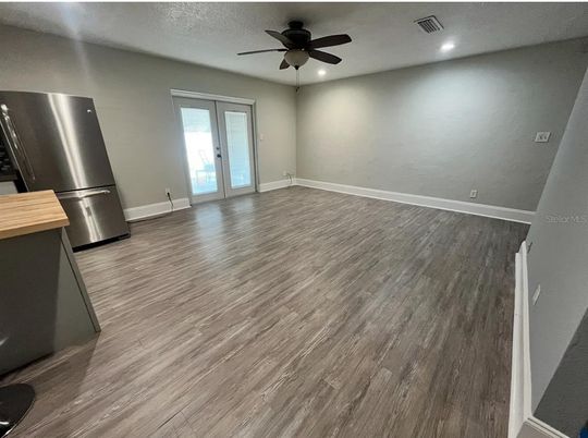 Empty room, Interior, Kitchen, Recessed Lighting, Stainless Steel Appliances, Wood Texture Flooring