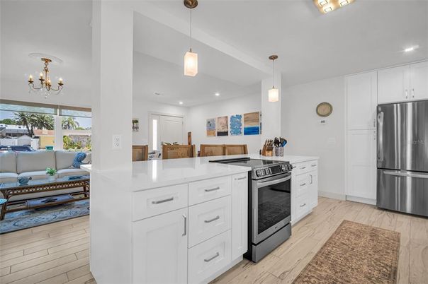 Chandelier, Interior, Kitchen, Living room, Pendant Lights, Recessed Lighting, Stainless Steel Appliances, Wood Texture Flooring