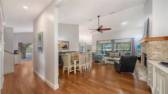 Dining room, Fireplace, Interior, Living room, Recessed Lighting, Stone Walls, Wood Texture Flooring