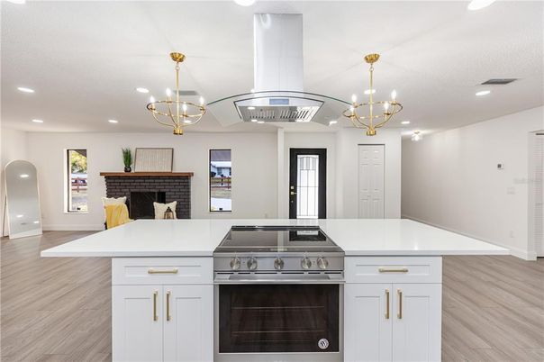 Chandelier, Fireplace, Interior, Kitchen, Pendant Lights, Recessed Lighting, Stainless Steel Appliances, Wood Texture Flooring