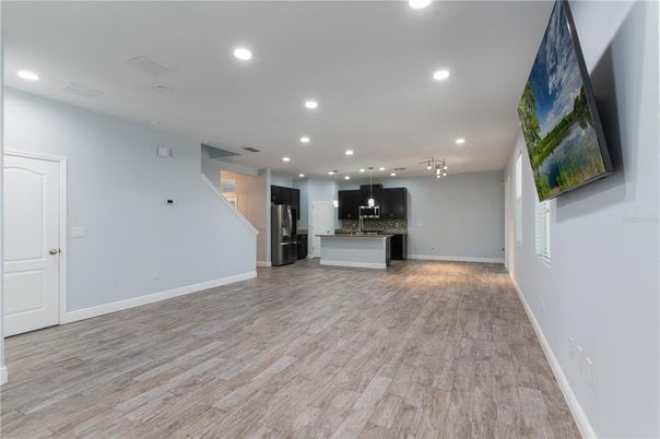 Empty room, Interior, Kitchen, Pendant Lights, Recessed Lighting, Stainless Steel Appliances, Wood Texture Flooring
