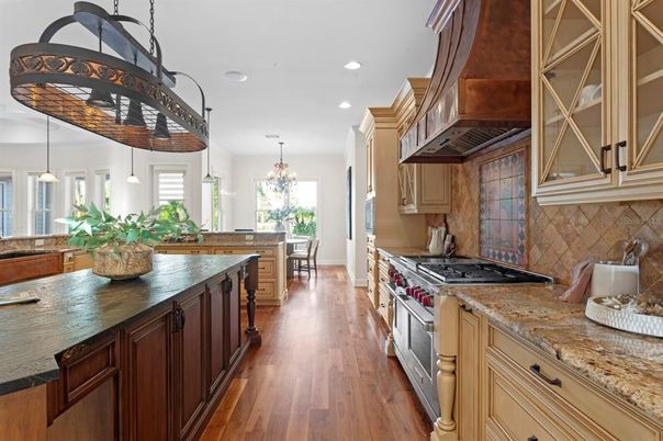 Chandelier, Dining room, Interior, Kitchen, Pendant Lights, Recessed Lighting, Stainless Steel Appliances, Wood Texture Flooring