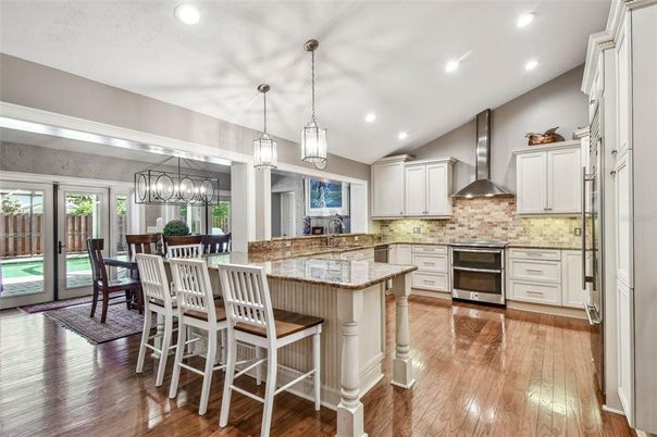 Chandelier, Dining room, Interior, Kitchen, Pendant Lights, Recessed Lighting, Stainless Steel Appliances, Wood Texture Flooring