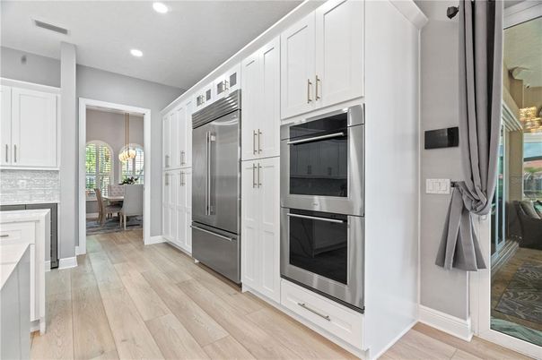 Chandelier, Dining room, Interior, Kitchen, Pendant Lights, Recessed Lighting, Stainless Steel Appliances, Wood Texture Flooring