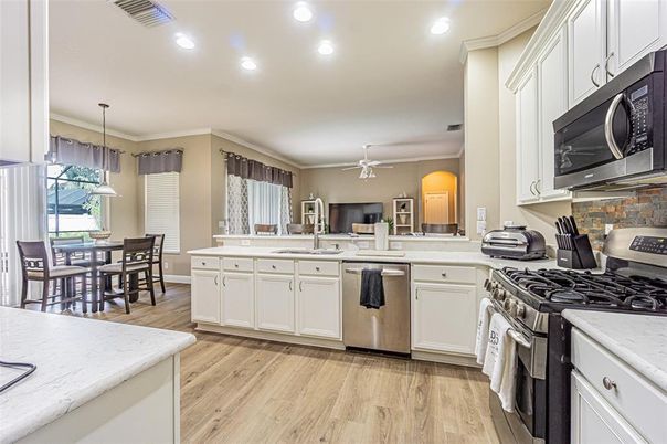 Dining room, Interior, Kitchen, Pendant Lights, Recessed Lighting, Stainless Steel Appliances, Wood Texture Flooring