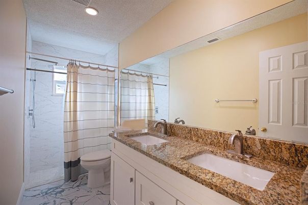 Bathroom, Dual Sink Vanities, Glass Shower, Interior, Marble, Marble Walls, Recessed Lighting