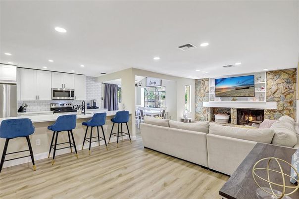 Dining room, Fireplace, Interior, Kitchen, Living room, Recessed Lighting, Stainless Steel Appliances, Stone Walls, Wood Texture Flooring