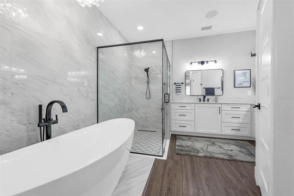Bathroom, Free Standing Baths, Glass Shower, Interior, Marble, Marble Walls, Recessed Lighting, Wood Texture Flooring