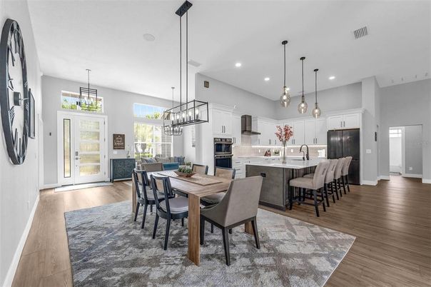 Chandelier, Dining room, Interior, Kitchen, Pendant Lights, Recessed Lighting, Stainless Steel Appliances, Wood Texture Flooring