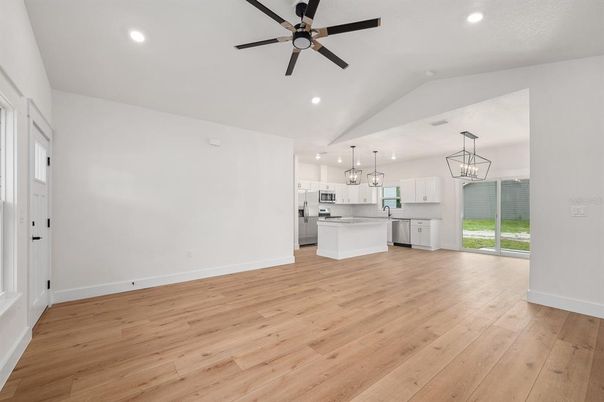 Chandelier, Empty room, Interior, Kitchen, Pendant Lights, Recessed Lighting, Stainless Steel Appliances, Wood Texture Flooring
