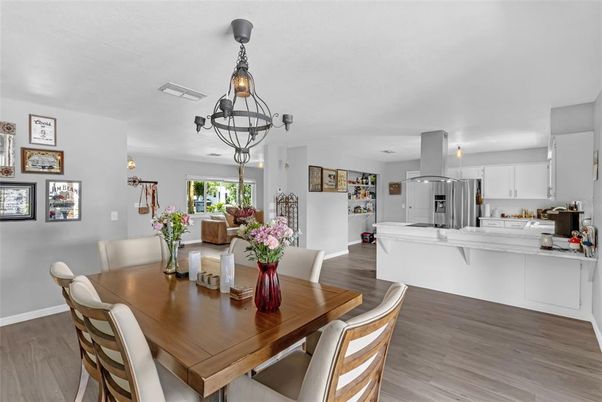 Chandelier, Dining room, Interior, Kitchen, Pendant Lights, Stainless Steel Appliances, Wood Texture Flooring