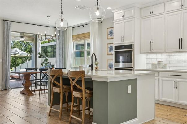 Chandelier, Dining room, Interior, Kitchen, Pendant Lights, Recessed Lighting, Stainless Steel Appliances, Wood Texture Flooring