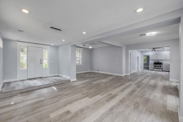 Empty room, Interior, Kitchen, Recessed Lighting, Stainless Steel Appliances, Wood Texture Flooring
